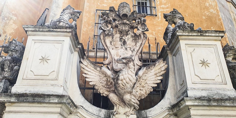 Águila Borghese con tiara papal y llaves coronando la puerta del recinto de la fuente del Acqua Paola en el Janículo, Roma