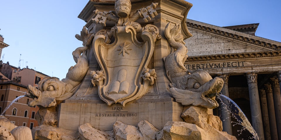 Escudo de Clemente XI e inscripción SPQR Restaurata 1880 en la fuente del Panteón